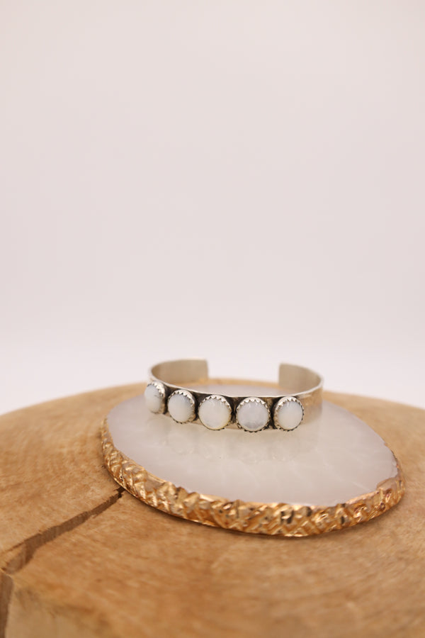 Hammered sterling silver cuff with 5 mother of pearl rounds in a line in the center