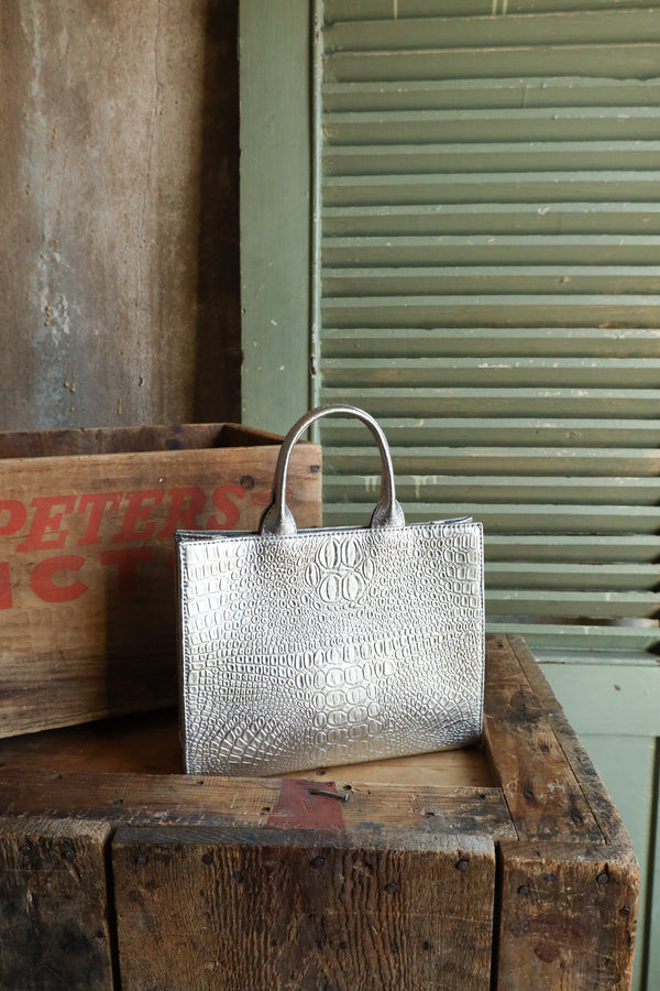 Silver structured handbag in a snake print with handles and also detachable matching strap