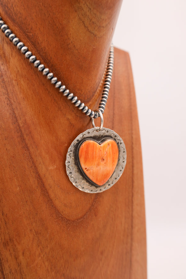 Sterling silver hammered pendant with hand stamped squiggle and dot boarder with large spiny oyster heart in the center