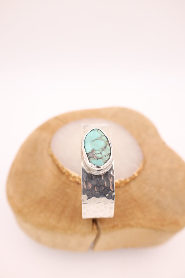 Hammered sterling silver cuff with oval turquoise stone in the center