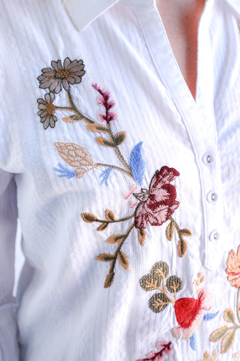 White blouse with colorful floral embroidery