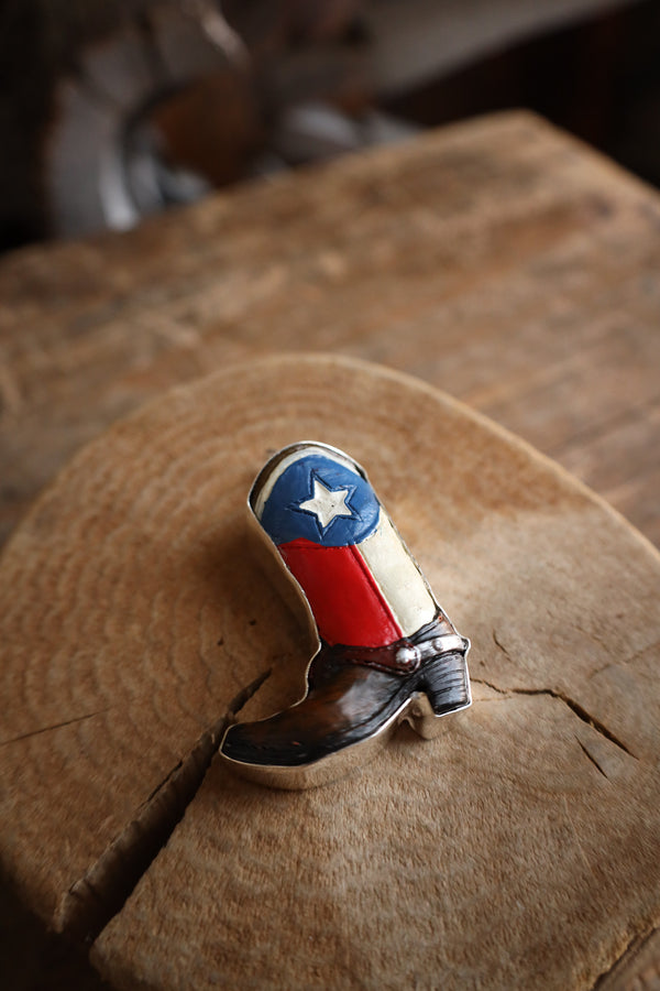 Cowboy boot with American flag design on a wooden surface