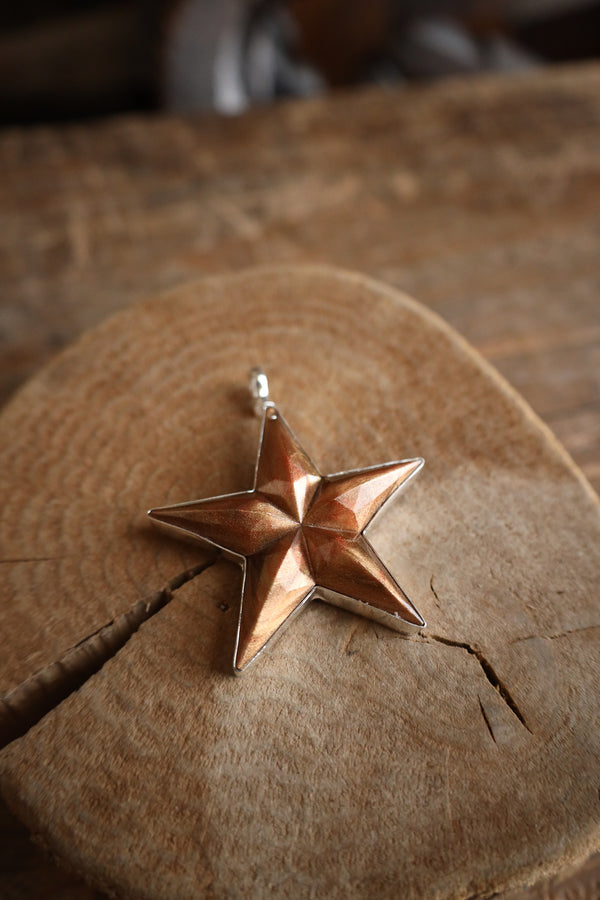Star-shaped pendant on a wooden surface