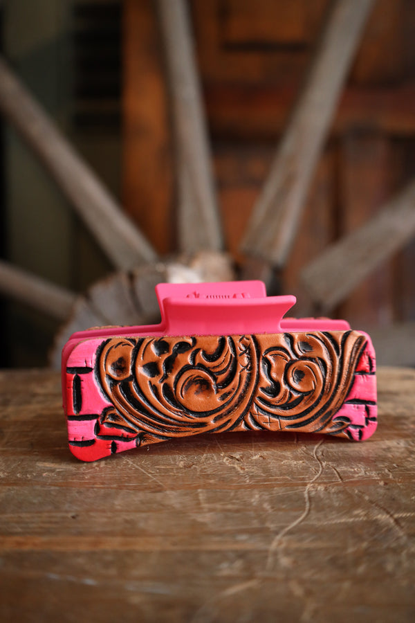Pink and brown decorative item on a wooden surface with blurred background