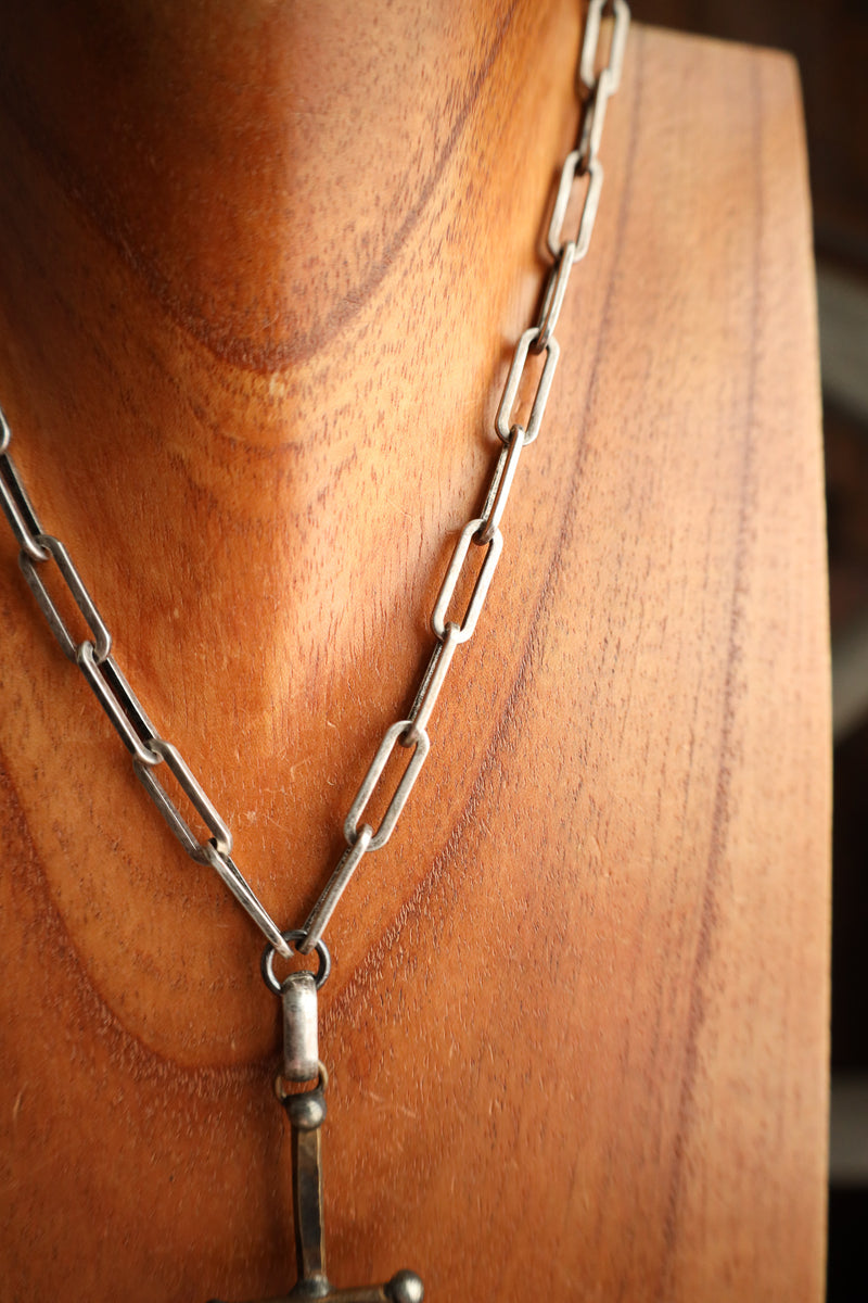 Silver chain necklace on a wooden surface