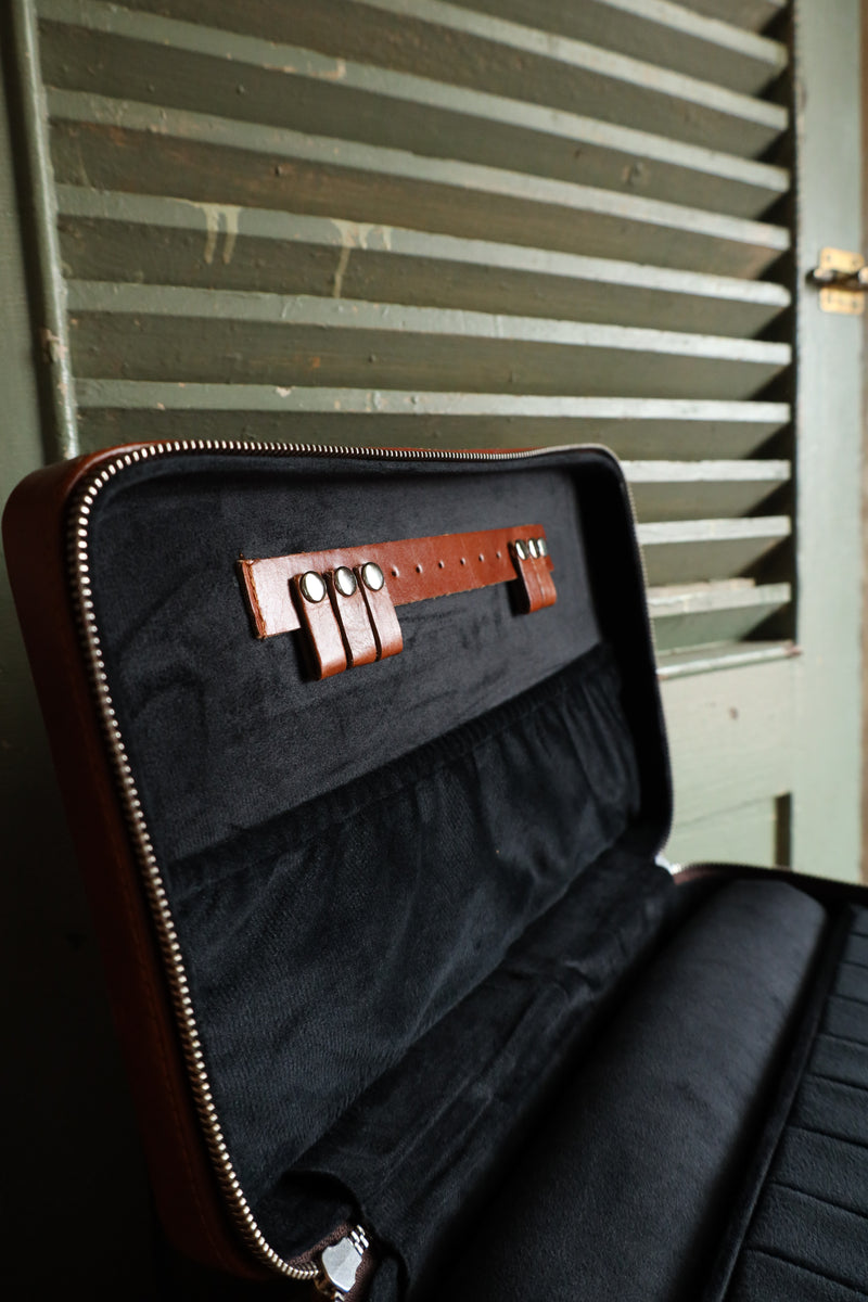 Double decker jewelry case with cowhide exterior and leather tooling and includes travel strap