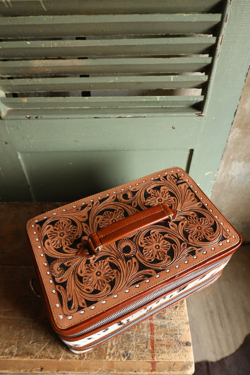 Double decker jewelry case with cowhide exterior and leather tooling and includes travel strap