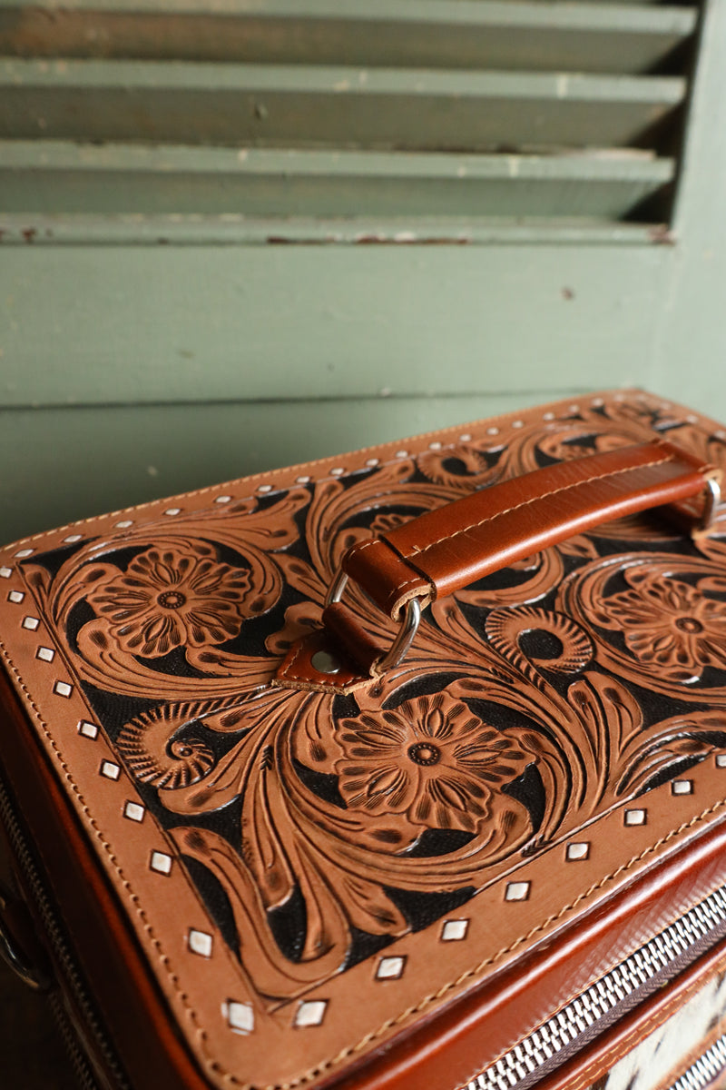 Double decker jewelry case with cowhide exterior and leather tooling and includes travel strap