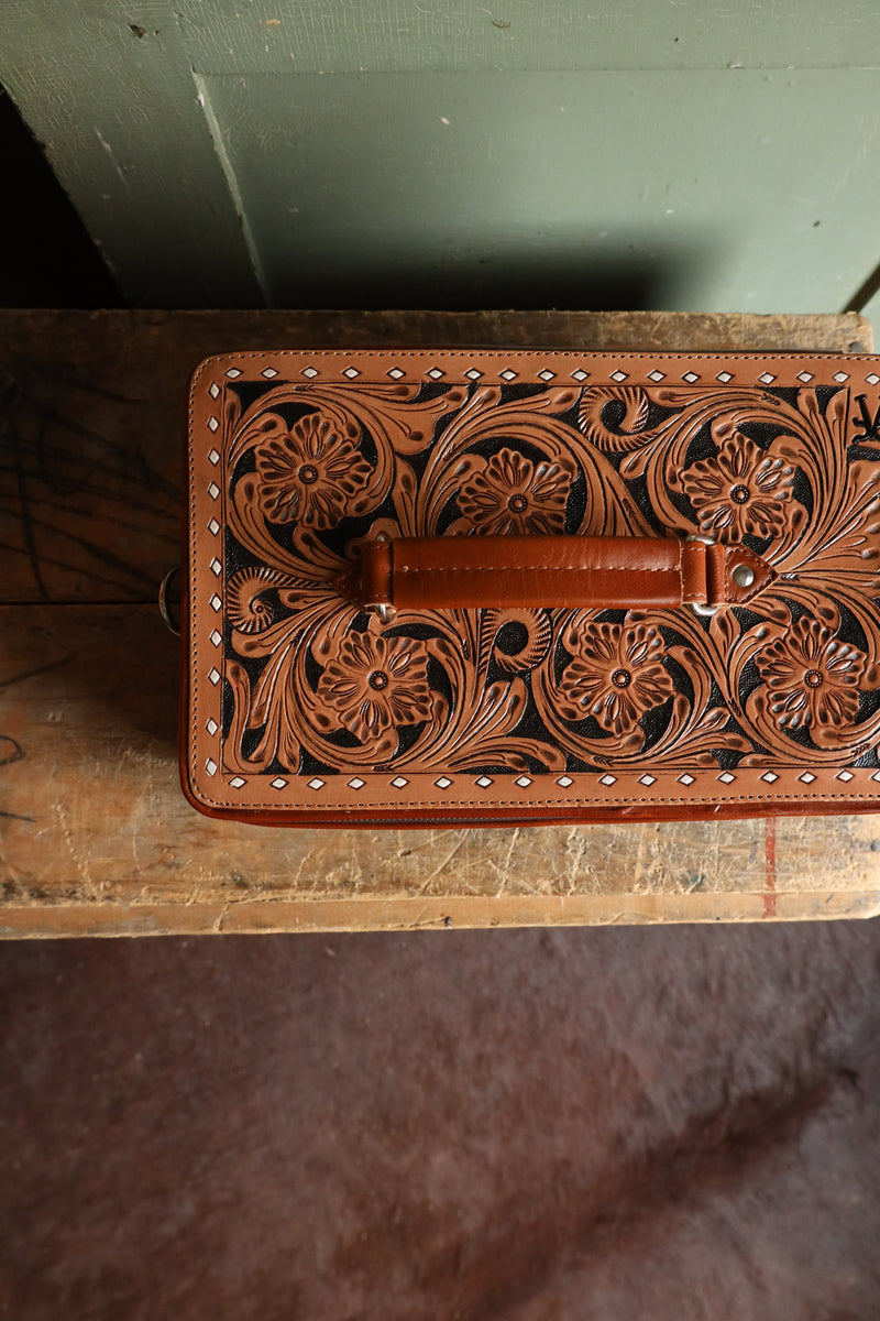 Double decker jewelry case with cowhide exterior and leather tooling and includes travel strap