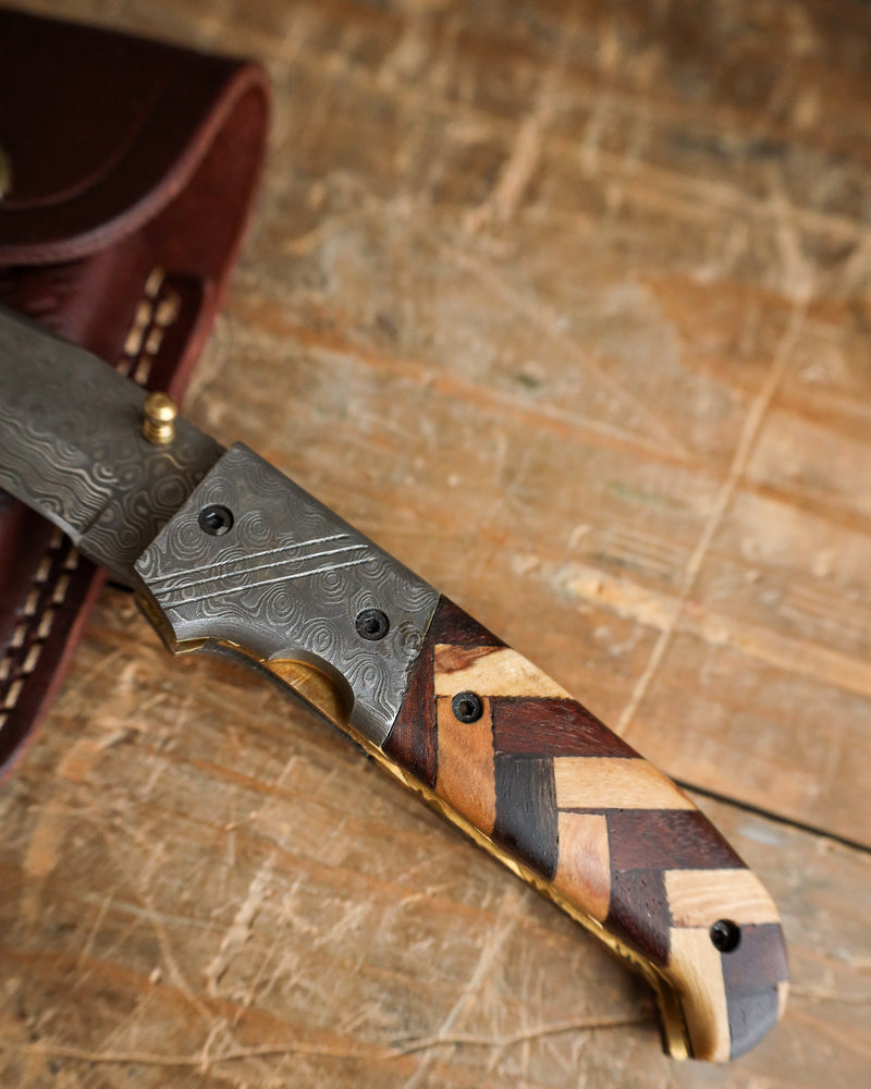 Close-up of a knife with a wooden handle on a wooden surface