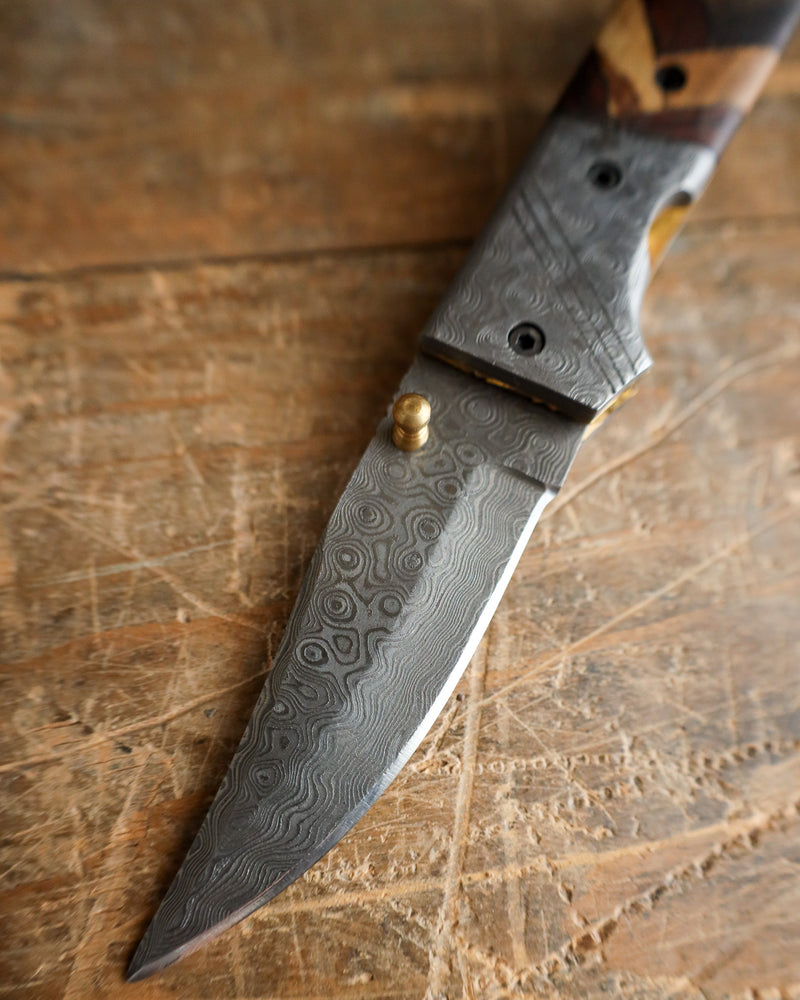 Decorative knife with a wooden handle on a wooden surface