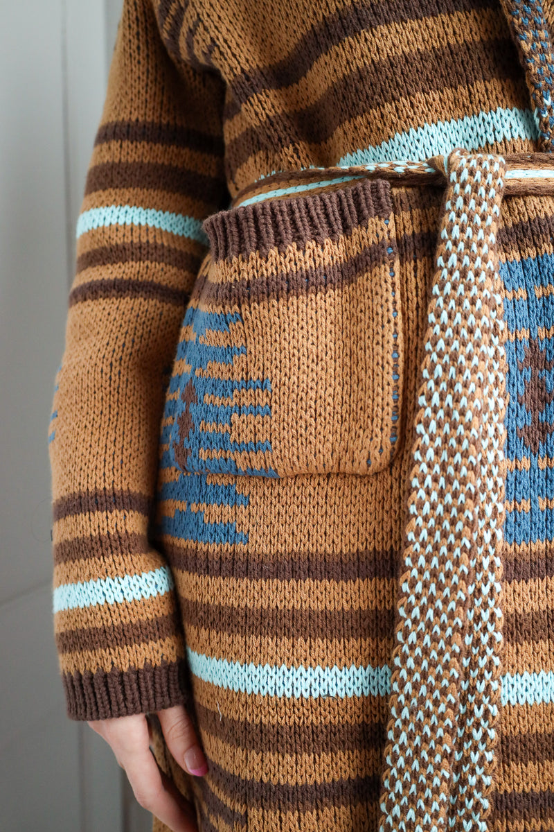 Close-up of a brown and blue patterned sweater with a matching bag.
