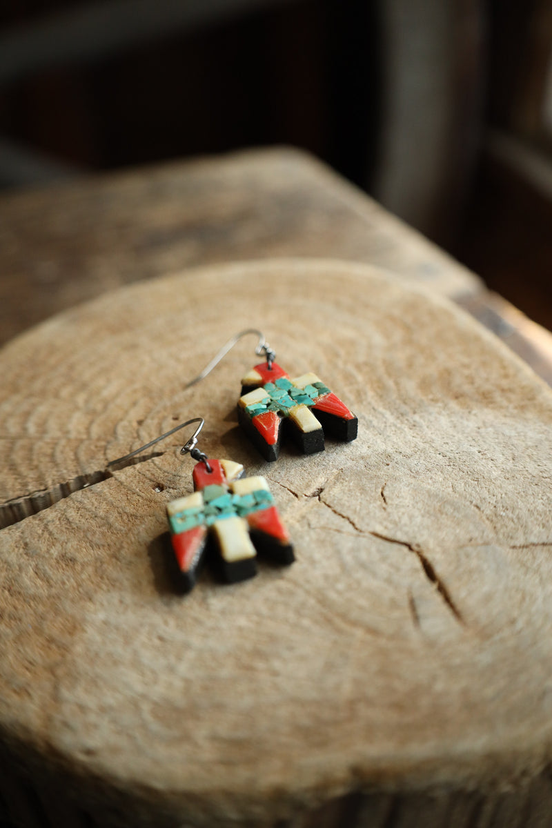 Colorful earrings on a wooden surface