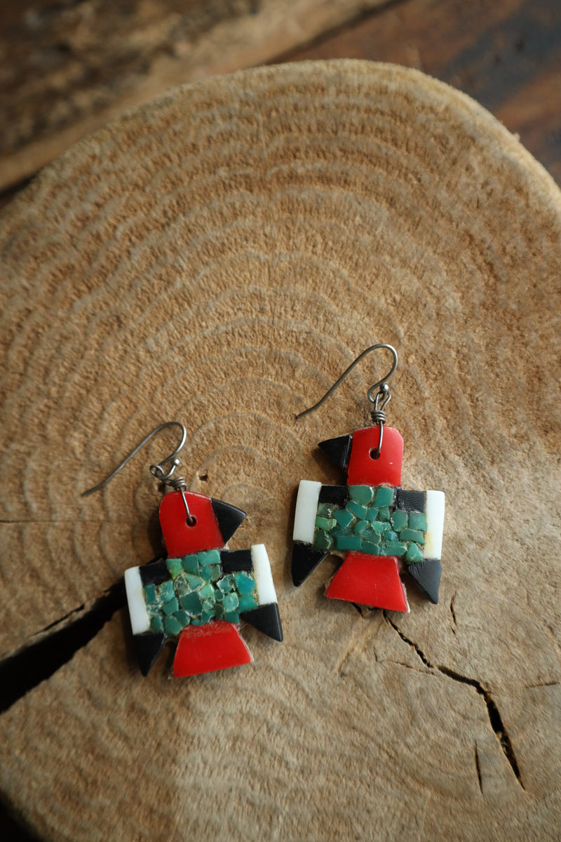 Colorful earrings on a wooden surface