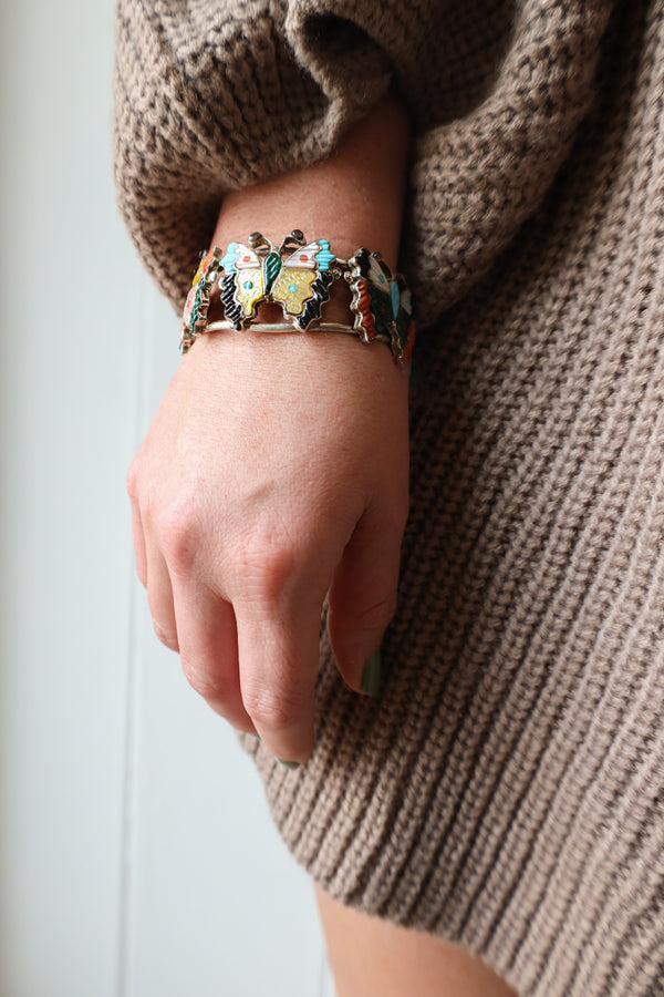 Woman wearing Western cuff with three butterflies adorned in Sterling Silver, Natural Stone and Shell