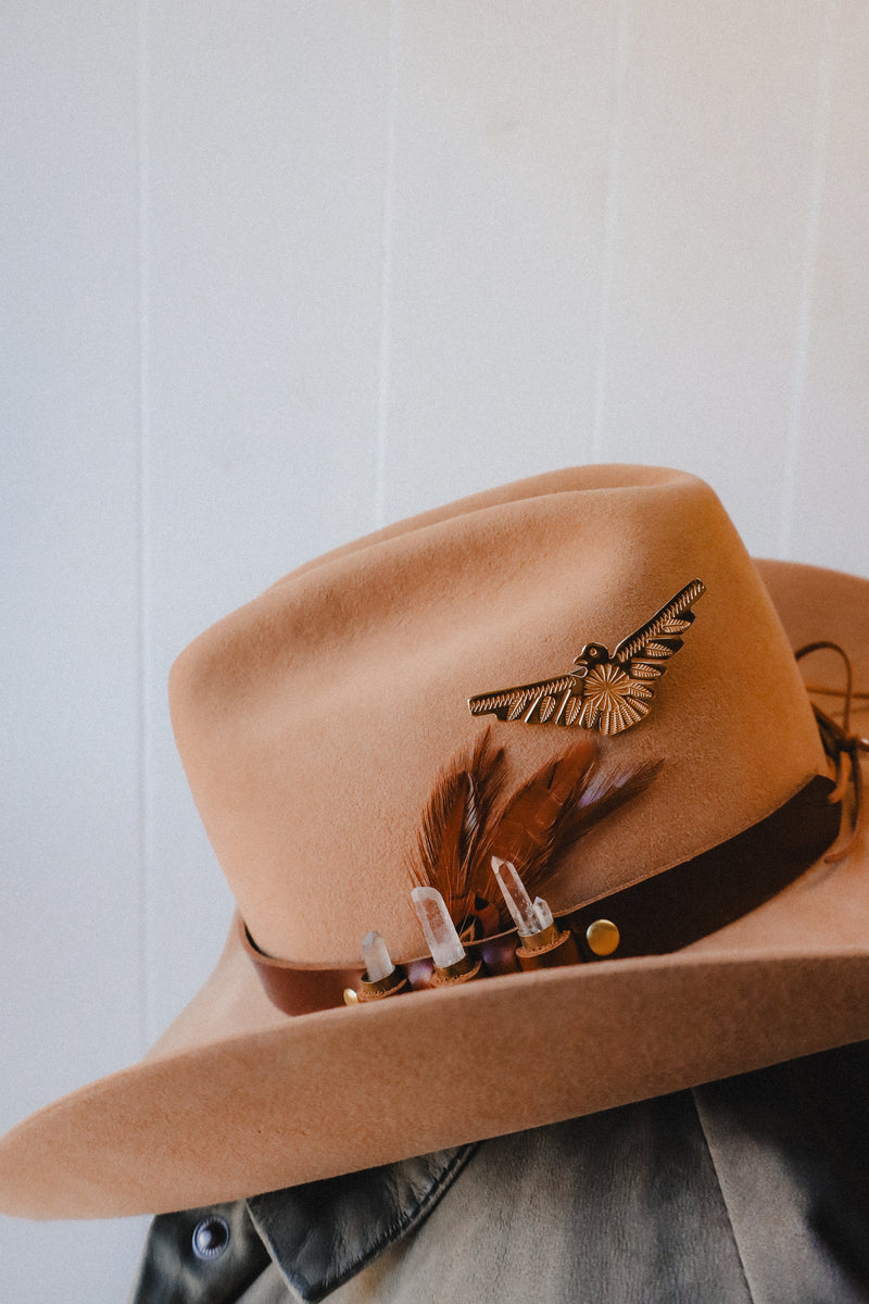 Featuring genuine leather, crystal adorned shotgun shells and an adjustable tie, this hatband is the perfect way to elevate your western style.