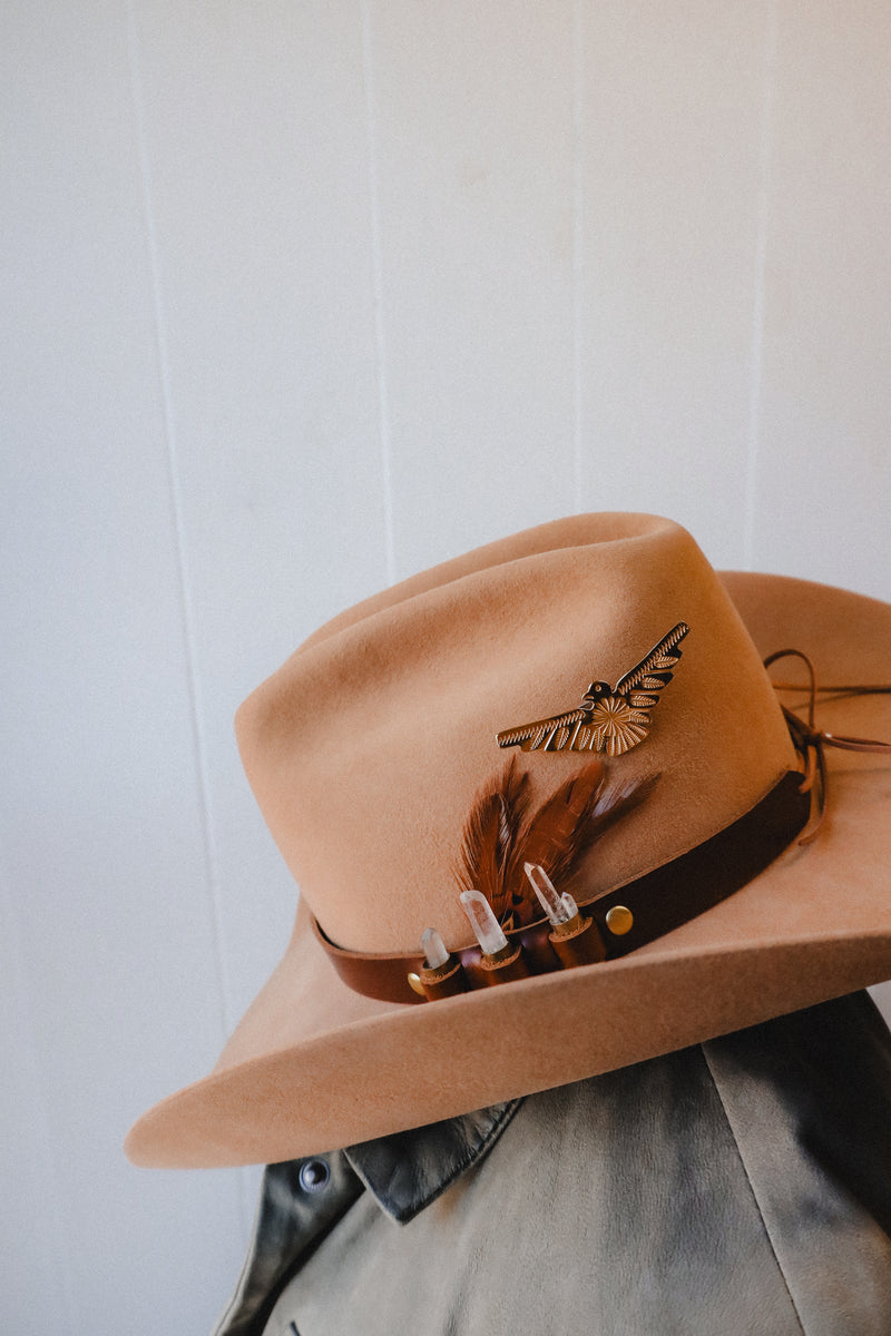 Featuring genuine leather, crystal adorned shotgun shells and an adjustable tie, this hatband is the perfect way to elevate your western style.