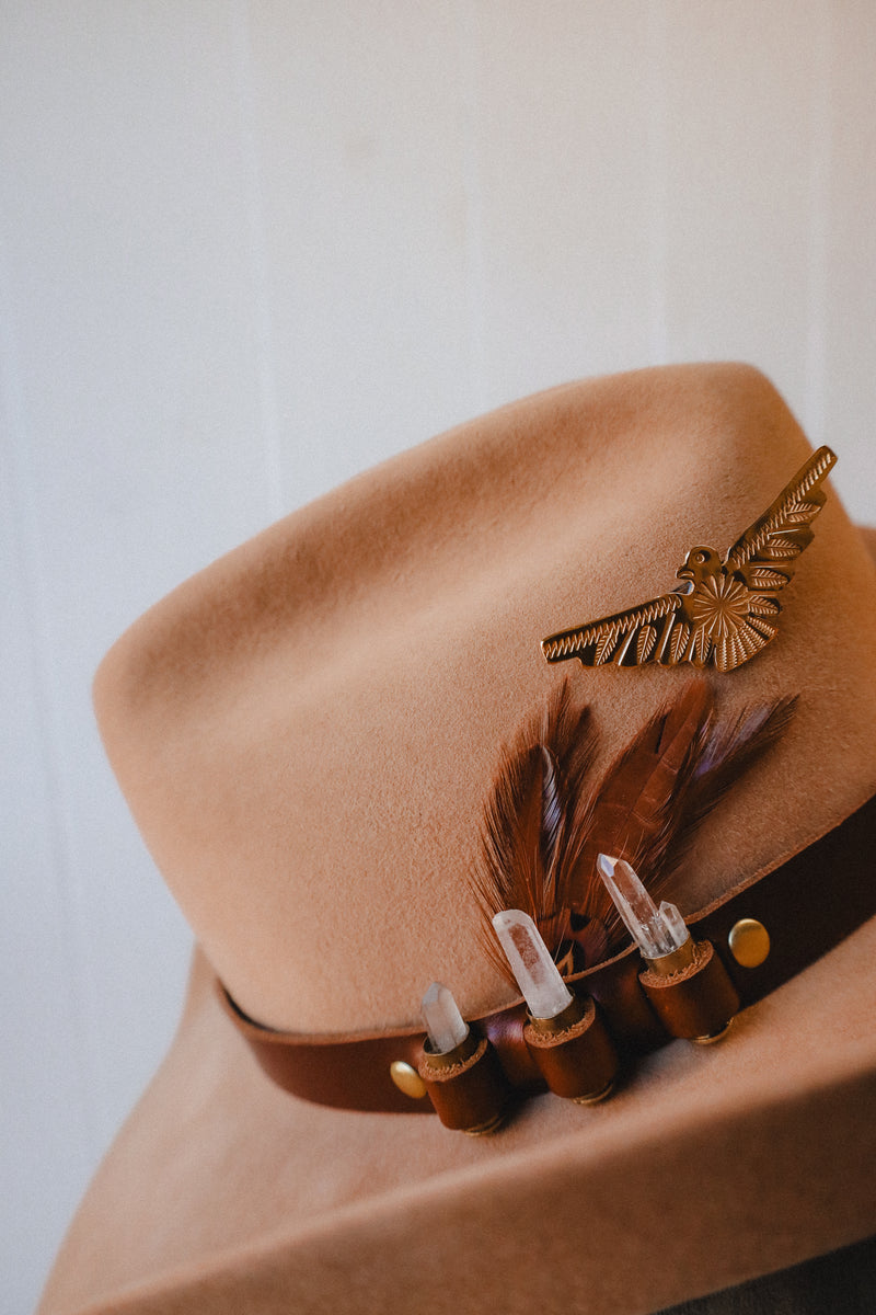 Featuring genuine leather, crystal adorned shotgun shells and an adjustable tie, this hatband is the perfect way to elevate your western style.