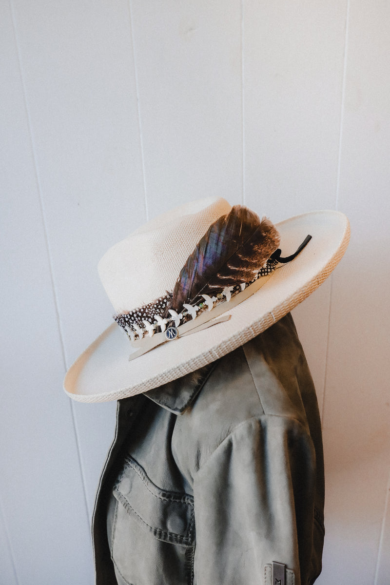 Black and white dot feather hat band with leather straps in the back to secure to any cowboy hat