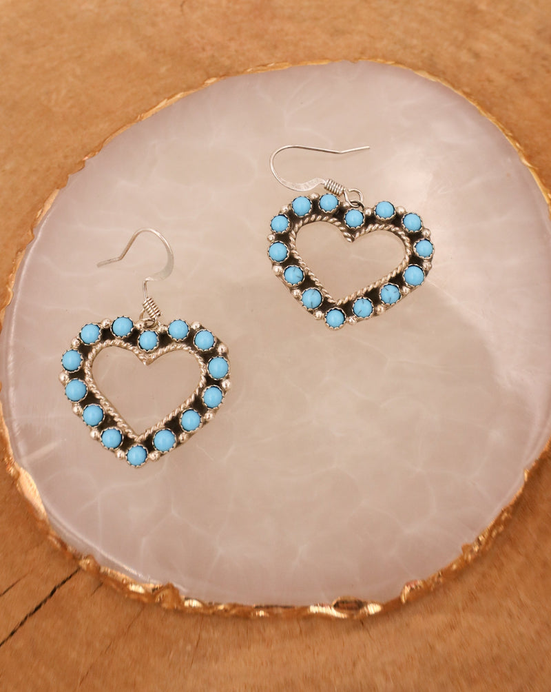 Made of high-quality sterling silver, these western-inspired dangle earrings are adorned with beautiful turquoise dots that add a pop of color. 