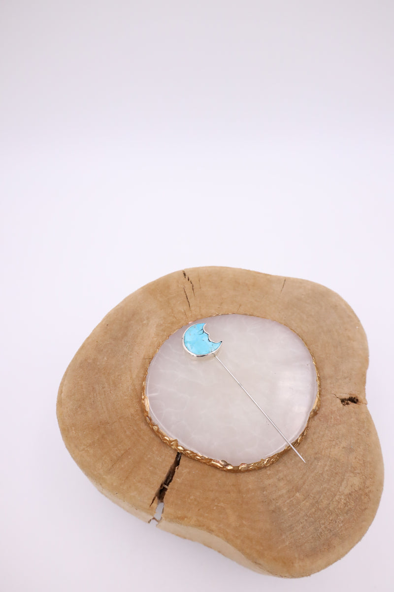Turquoise stone with half moon shape and face cut into the stone stick hat pin