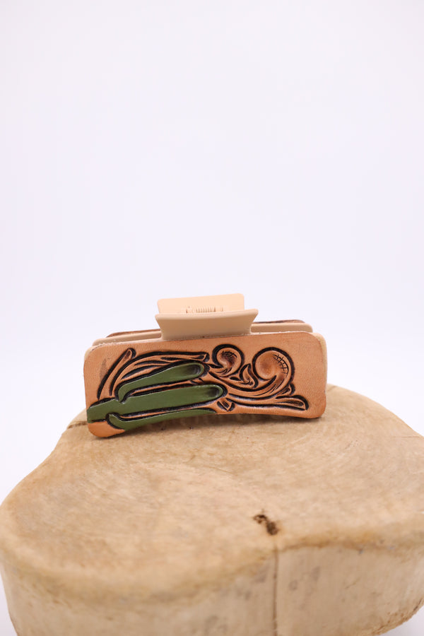 Hand tooled leather claw clip with saguaro and scroll design on either side