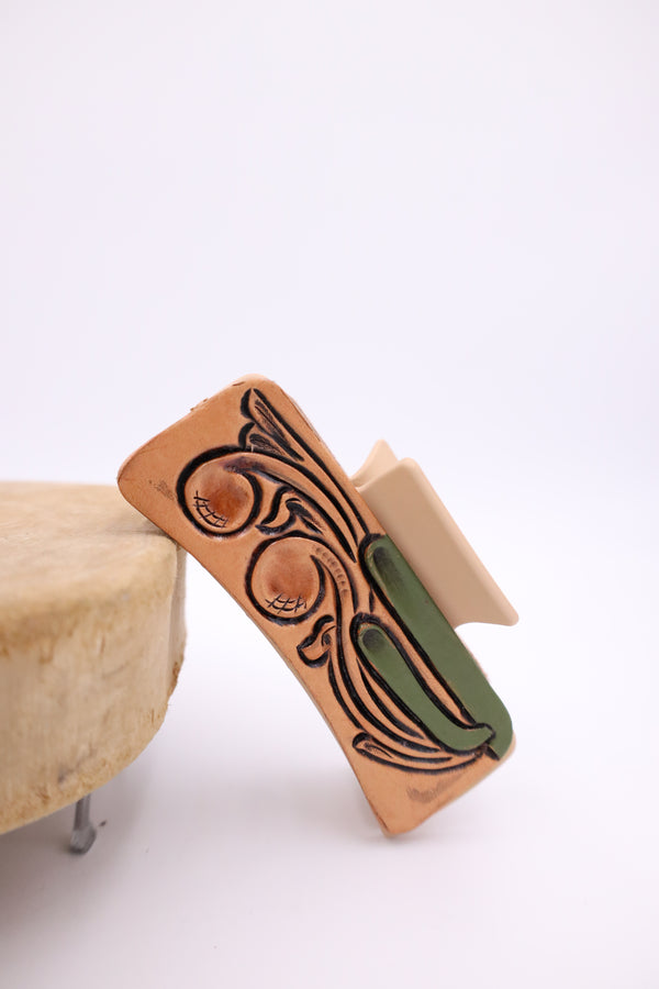 Hand tooled leather claw clip with saguaro and scroll design on either side