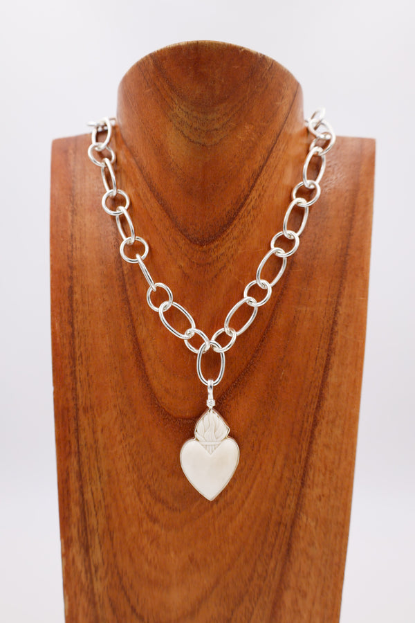 White heart pendant with crown on the top.