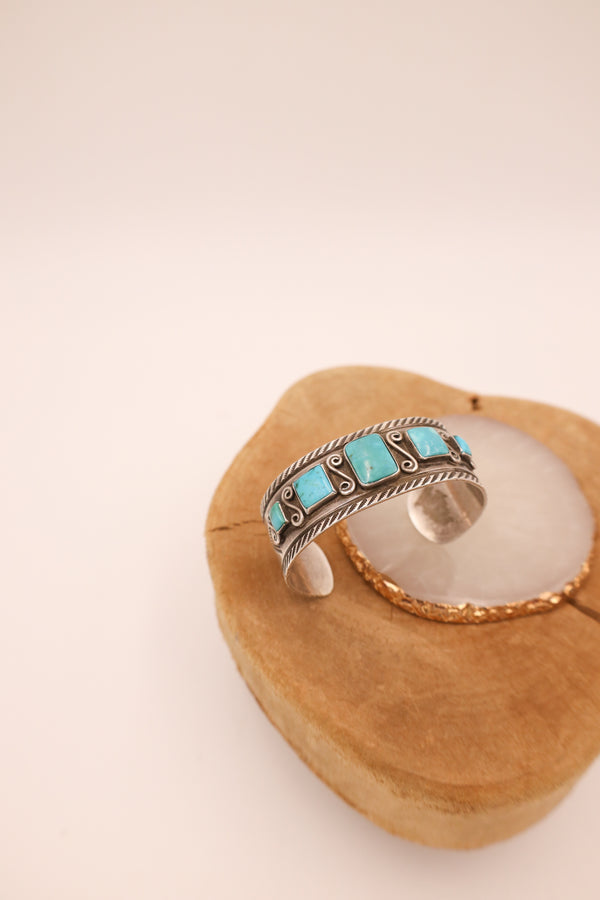 5 Turquoise squares on sterling silver cuff with sterling silver squiggles in between turquoise squares