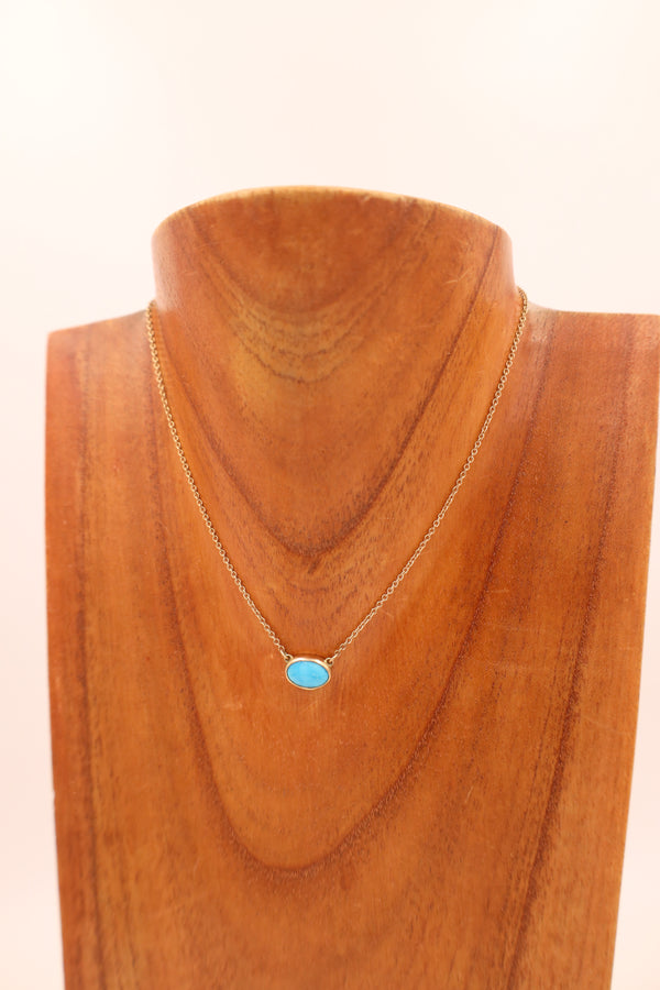 Turquoise oval gold necklace.