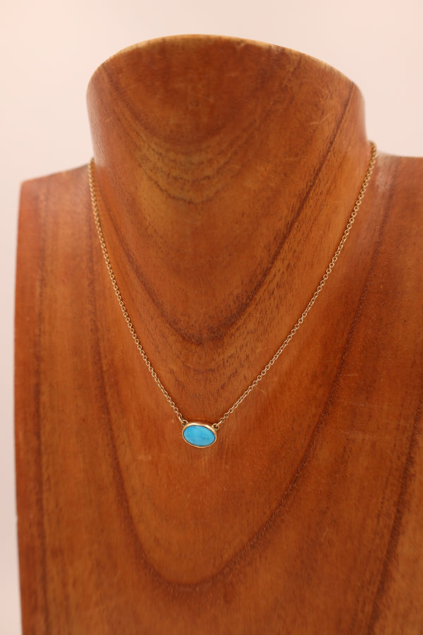 Turquoise oval gold necklace.