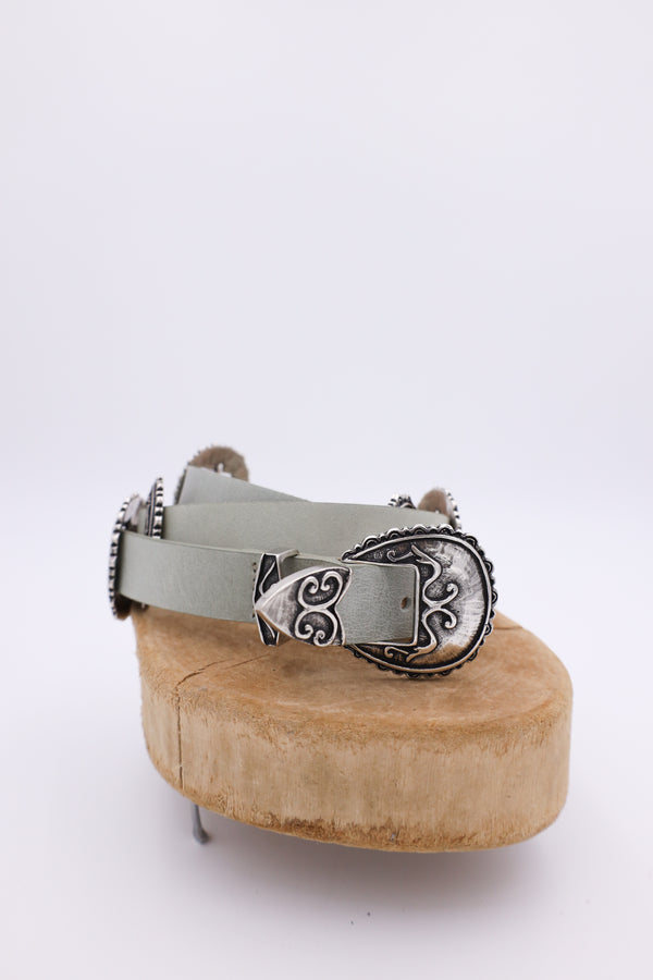 Sage leather belt with silver conchos on it 