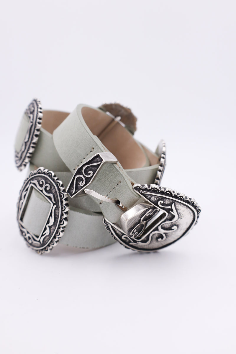 Sage leather belt with silver conchos on it