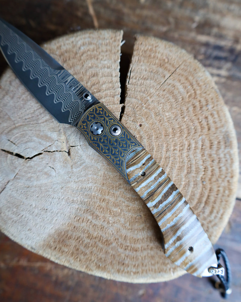 WILLIAM HENRY Sierra Pocketknife with 24K gold koftgari, fossil Mammoth Tooth, and 'wave' damascus blade