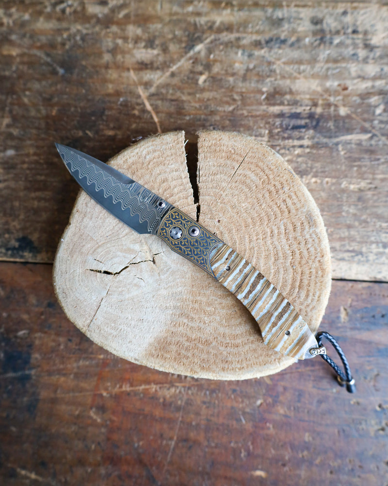 WILLIAM HENRY Sierra Pocketknife with 24K gold koftgari, fossil Mammoth Tooth, and 'wave' damascus blade