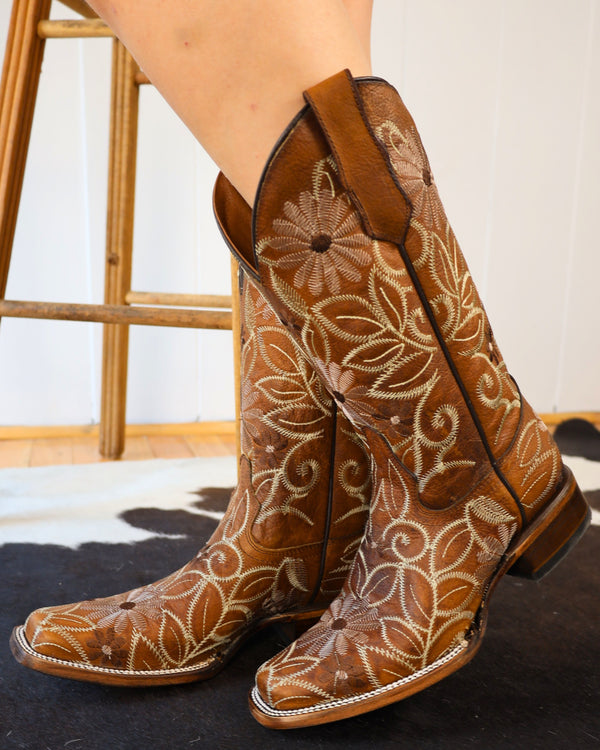 Tan cowboy boot with white and brown floral embroidery
