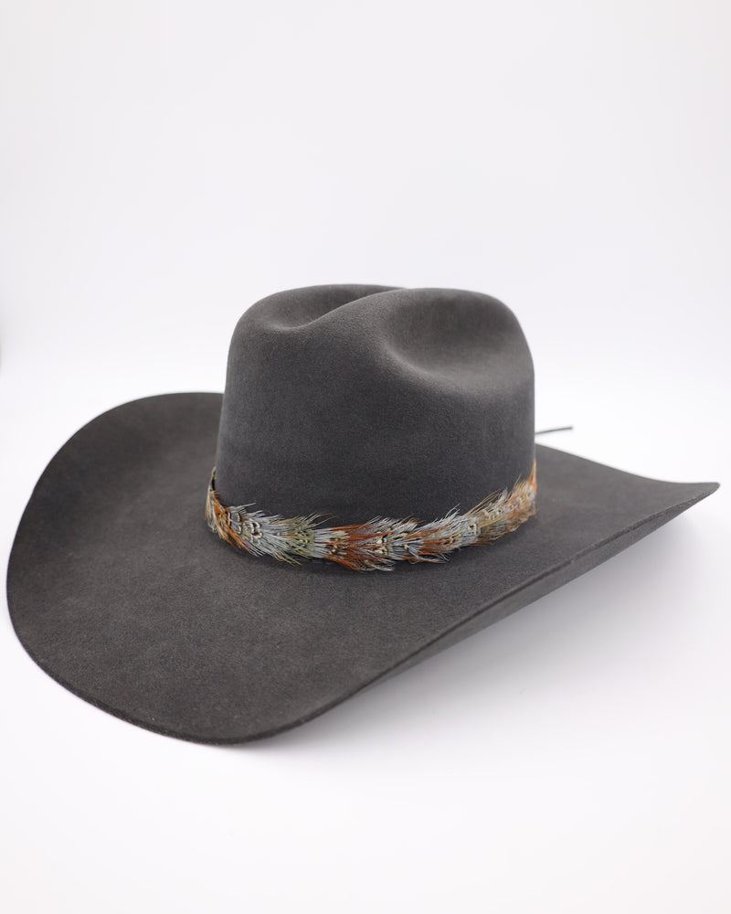 Pheasant feather hat band with leather ties in the back portion.