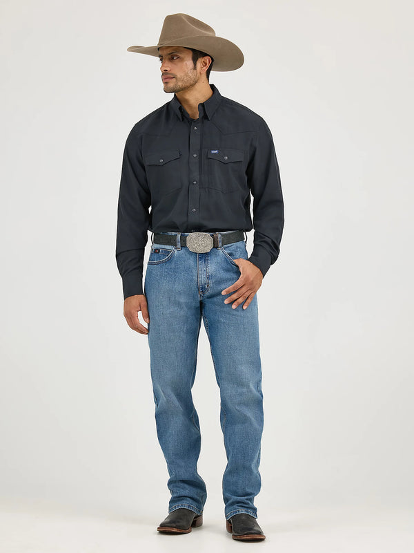 Man wearing a black shirt, blue jeans, and a brown cowboy hat on a white background