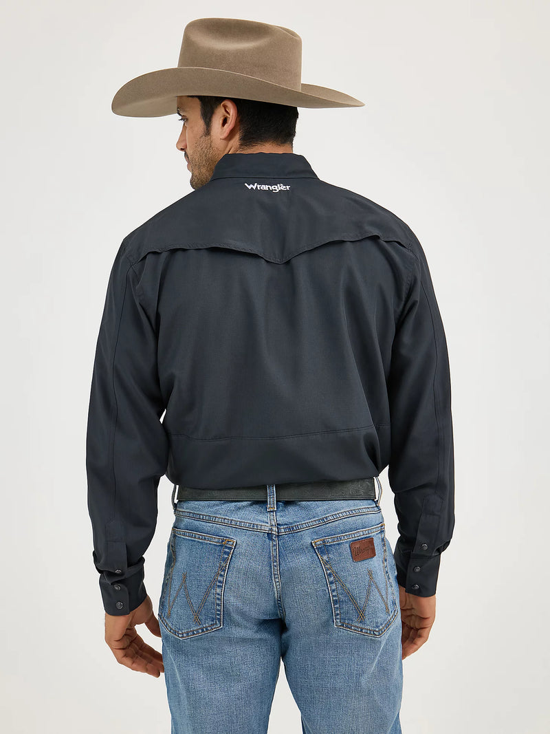 Man wearing a black jacket with 'Wrangler' branding, blue jeans, and a brown cowboy hat on a white background.