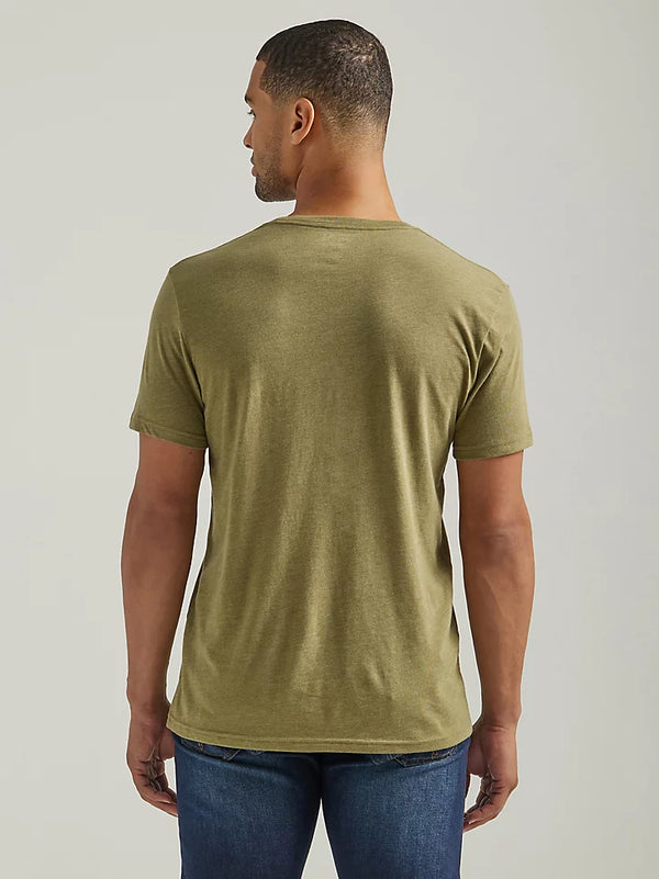 Man wearing olive green t-shirt with script "Damn Strait Wrangler" on front