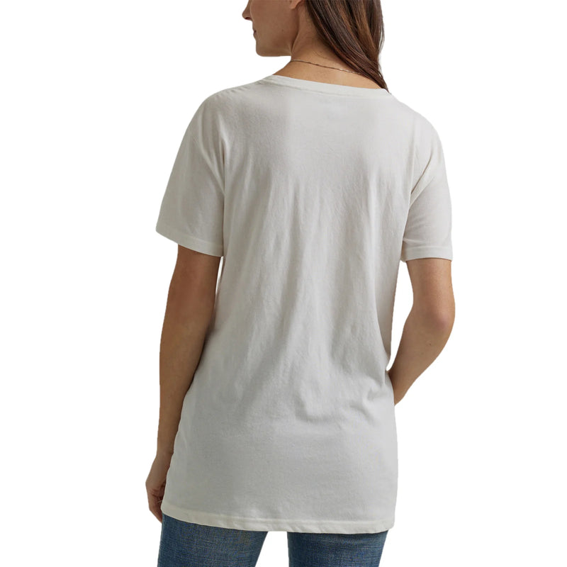 Woman wearing white t-shirt with graphic of woman riding a horse with "wrangler" written under it
