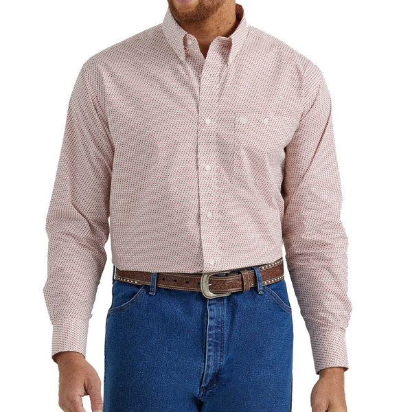 Man wearing long sleeved button down with red and white pattern and single button breast pocket