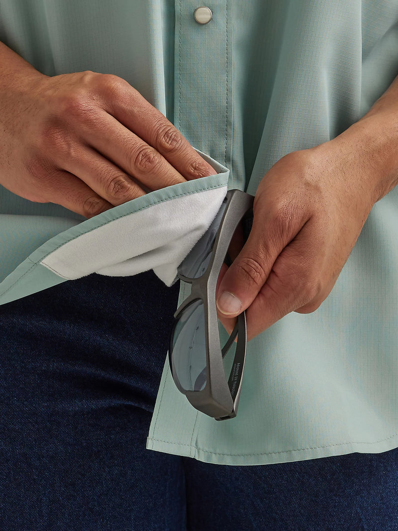 Man wearing performance short sleeve shirt with button front and vents in the back