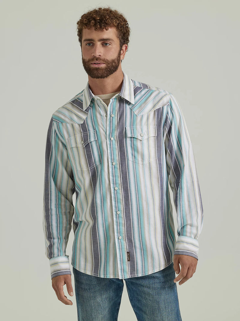 Man wearing long sleeve shirt with button front, stripes and western yokes