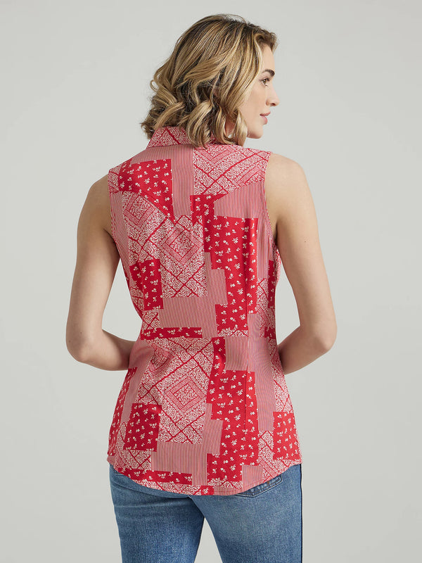 Woman wearing sleeveless pearl snap shirt with patch design with stripes and bandana print