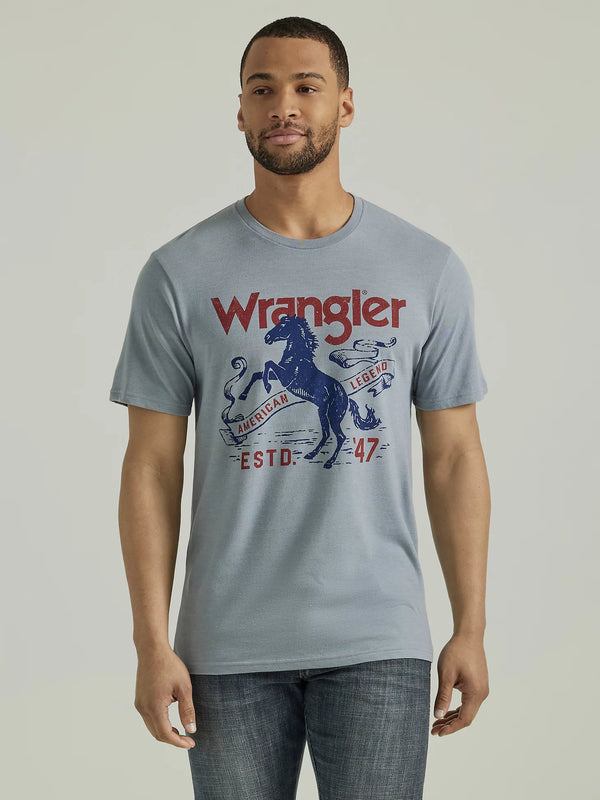 Man wearing graphic tee with image of horse on its hind legs with script "Wrangler American Legend ESTS. 47"