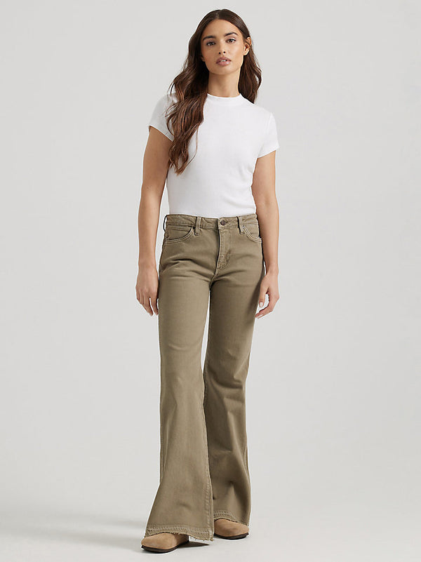 Woman wearing tan bell bottom pants with mid rise waist and Wrangler W on the pockets