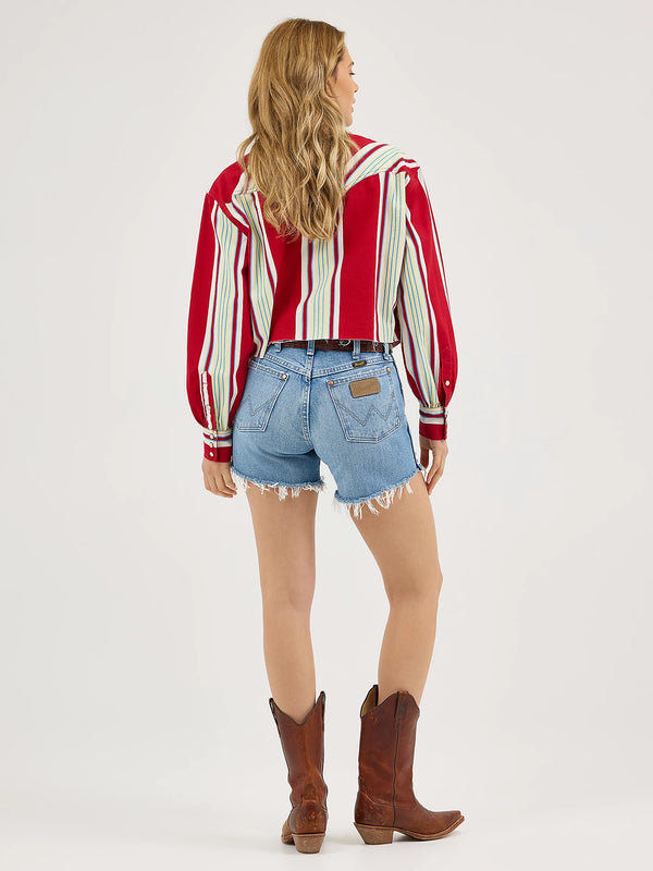 Person wearing a red and white striped shirt, blue denim shorts, and brown cowboy boots on a white background