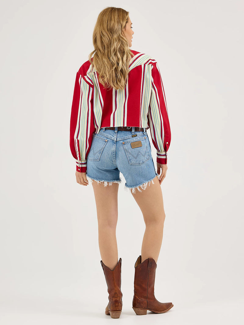 Person wearing a red and white striped shirt, blue denim shorts, and brown cowboy boots on a white background