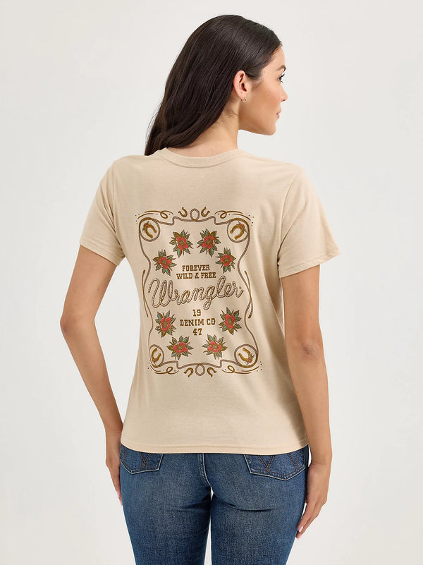 Woman wearing a beige t-shirt with Wrangler logo and text on a plain background